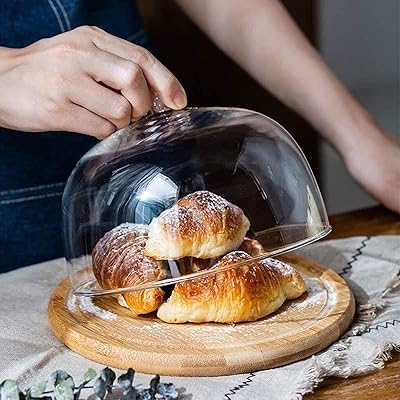 Présentoir à gâteau tournant q&w 32 cm avec couvercle en forme de dôme, plateau de service rond en bois pour gâteau de mariage avec couvercle en verre et dessus en bois. DIAYTAR COTE D'IVOIRE est une boutique en ligne généraliste qui propose plus de 300 000 références de produits variés, faisant d'elle le leader du marché ivoirien. Elle offre une gamme large de produits allant des électroniques aux produits alimentaires, en passant par la mode et la décoration. Avec DIAYTAR, les clients peuvent faire leurs achats en ligne en toute sécurité.